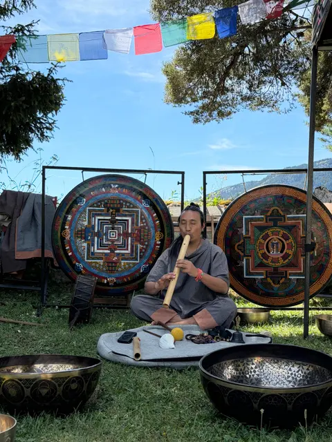Pasang Lama playing between mandala gongs outdoors