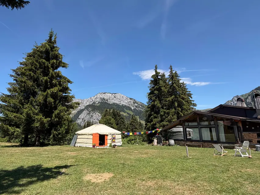 The retreat site: yurt and chalets facing the mountains
