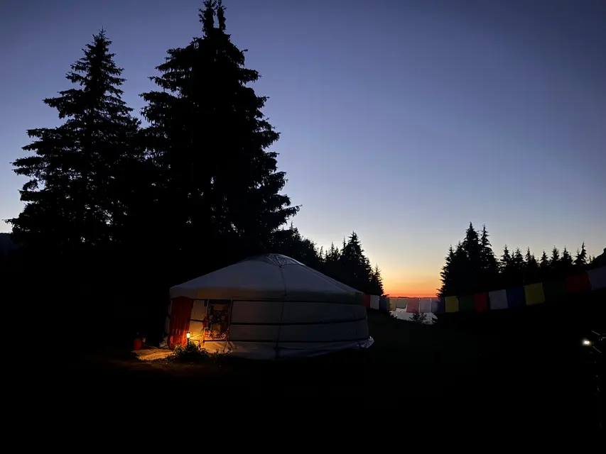 The retreat site: yurt and chalets facing the mountains