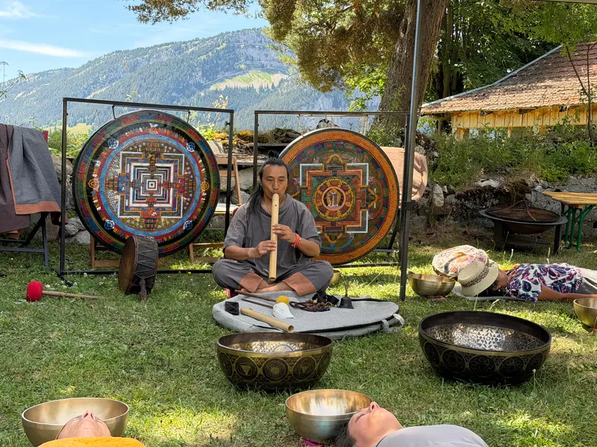 Pasang Lama playing between mandala gongs outdoors