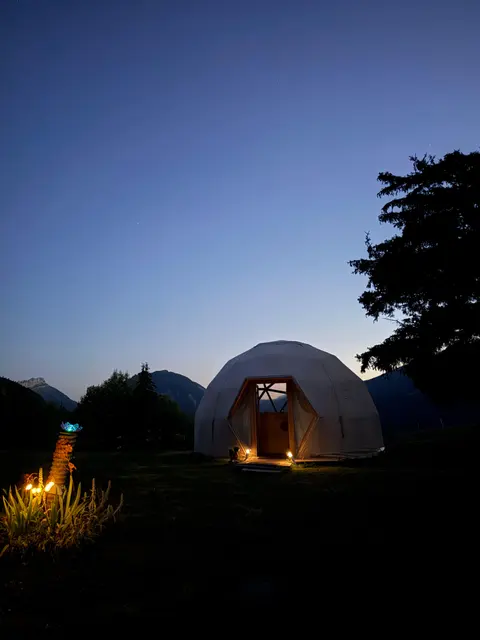 The retreat site: yurt and chalets facing the mountains