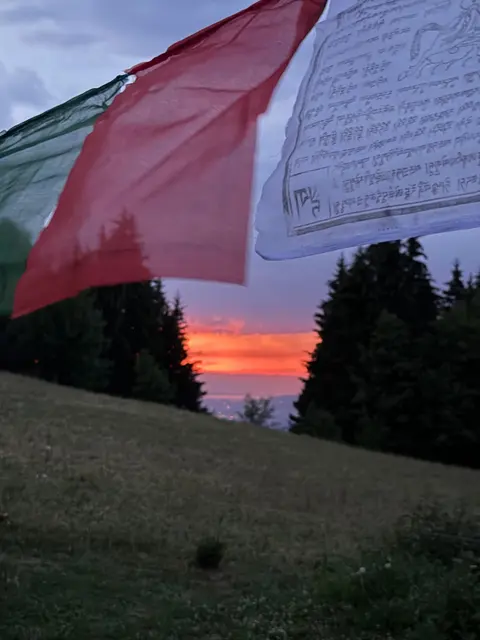 Prayer flags floating above the camp
