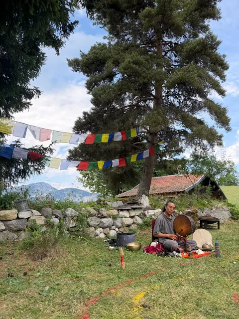 Pasang Lama playing between mandala gongs outdoors